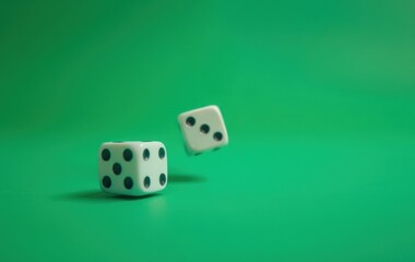 Two Dice Rolling on Vibrant Green Background for Game and Luck Concepts