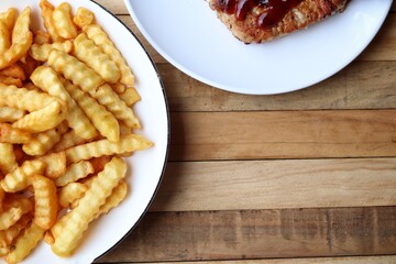 French fries on wood background