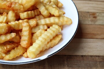 French fries on wood background