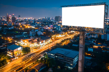 Obraz premium Aerial view of blank billboard over vibrant nightlife district, city lights below.