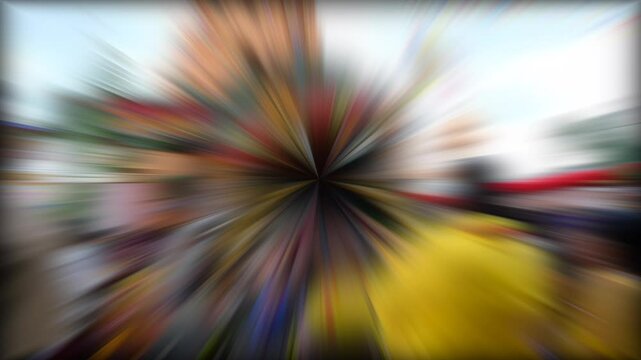  Image features a dynamic, radial blur effect with a burst of colors converging towards the center, creating a sense of motion and energy with vibrant tones.