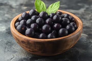 Bowl full of acai berries on a gray table
