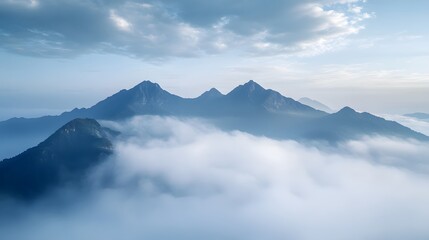 Foggy Mountain Landscape with Clouds and Snow-Capped Peaks