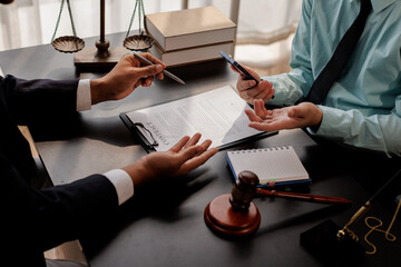 law and justice. Lawyer Legal counsel presents to the client a signed contract with gavel and legal...