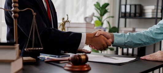 Justice Statue, Gavel, with Lawyer Handshake in Business Meeting with Scales of Justice and Gavel...