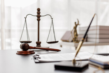 Justice statue, gavel, with LAW Justice lawyers having team meeting at law firm background. Concepts of Law and Legal services.
