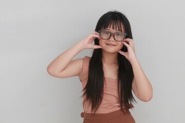 Playful kid posing with oversized glasses and a bright smile, showing a joyful and carefree attitude. Ideal for educational themes, imagination, and positive lifestyle concepts