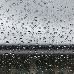 Water droplets scattered on a window glass