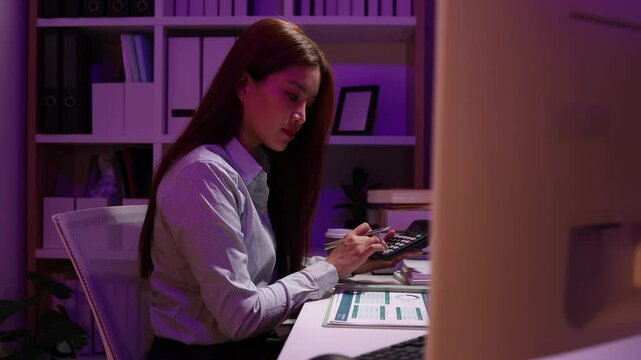 a businesswoman works late into the night because she has to deal with important contract documents that ned to be presented tomorrow, one of the employees worked overtime