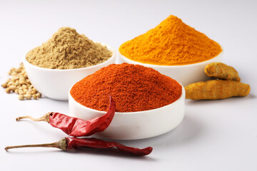 Chilli powder, haldi power, coriander powder, Indian spices served in ceramic bowls