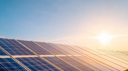 cluster of modern solar panels beneath clear blue sky with sun rays reflecting off their sleek surfaces