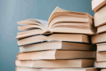 close-up view of stacked books with open pages offering glimpse into various subjects and genres