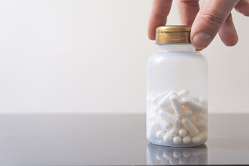 
Hand holding a bottle with magnesium capsules