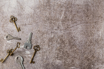 Collection of decorative aged keys on dark background. Flat lay, top view. Copy space