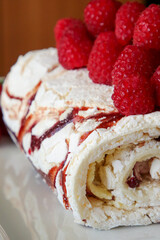 Fresh marbeled roulade or swiss roll with raspberries.