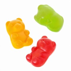 Colorful gummy bears arranged in bear shapes, overlapping on white background  yellow, green, and red.
