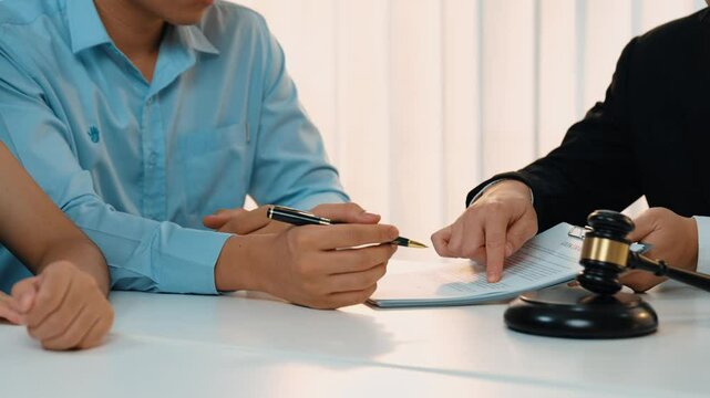 Couples file for divorcing and seek assistance from law firm to divide property after breakup. Obligations contract assist by lawyer in negotiating settlement agreement meeting. Slow motion. Rigid.