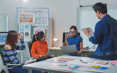 Group of asian young creative ui web designer team is brainstorming and working on developing...