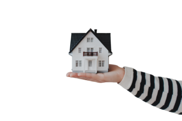 Hand holding miniature house model isolated on transparent background PNG 