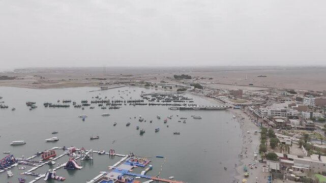 Drone shot above the city Paracas in Peru during a cloudy day LOG