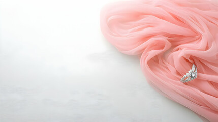 Elegant Diamond Ring on Soft Pink Fabric Drape Over White Surface