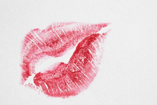 red lipstick kiss print on white paper