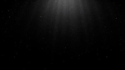 Obraz premium Black glitter glitter particles illuminated by light, creating a sparkling effect on a dark background