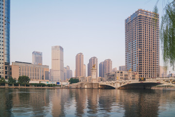 Obraz premium The urban architectural skyline, modern bridges, and Haihe River scenery of Tianjin, China on August 11, 2024 