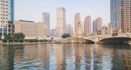 Obraz premium The urban architectural skyline, modern bridges, and Haihe River scenery of Tianjin, China on August 11, 2024 