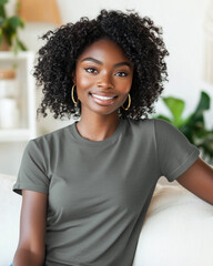 Fototapeta premium a black woman wearing plain t-shirt with no writing or images,sitting comfortably on a light-colored sofa in home,curly hair,large gold hoop earrings,smiling,white interior accents, houseplants