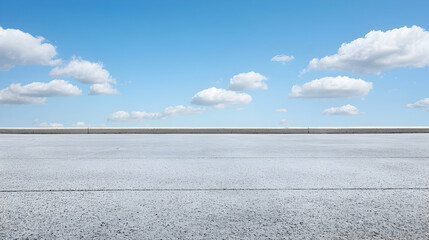 Obraz premium Asphalt Road Under Blue Sky With Fluffy White Clouds