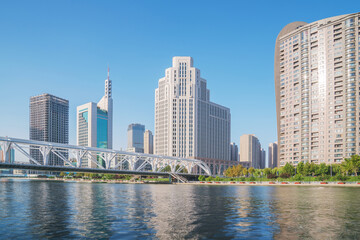 Obraz premium The urban architectural skyline, modern bridges, and Haihe River scenery of Tianjin, China on August 11, 2024