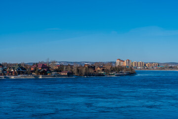 Obraz premium Irkutsk waterfront view in winter with snow on the mountaintops, Irkutsk Oblast, Russia
