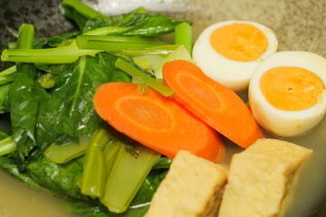 Japanese home-style dish of eggs, vegetables, and deep-fried tofu simmered together.