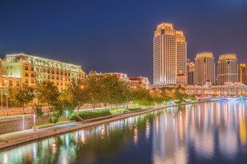 Fototapeta premium The urban architectural skyline, modern bridges, and Haihe River night scenery of Tianjin, China on August 11, 2024