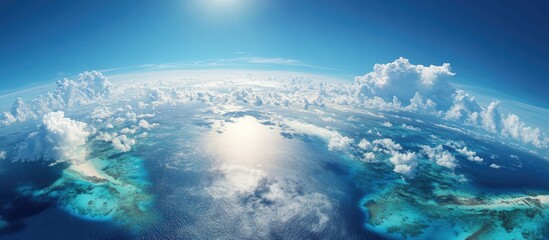 Aerial view of bright blue ocean with scattered clouds and white sandy shores reflecting sunlight creating a stunning natural panorama
