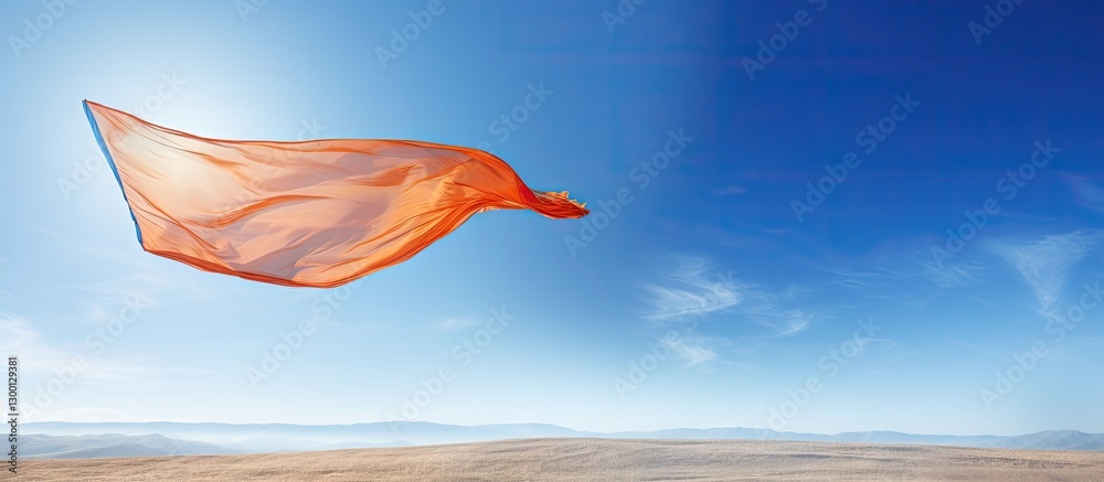 Poster vibrant orange fabric flowing in strong winds against a serene blue sky with gentle clouds creating 