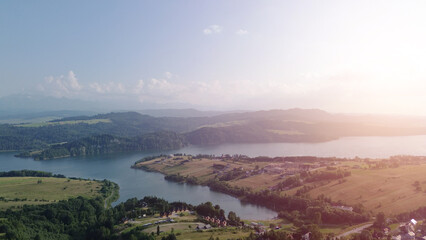 Fototapeta premium Lake Czorsztyn aerial view with green fields and mountains