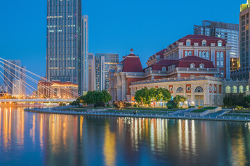 Obraz premium The urban architectural skyline, modern bridges, and Haihe River night scenery of Tianjin, China on August 11, 2024 ﻿