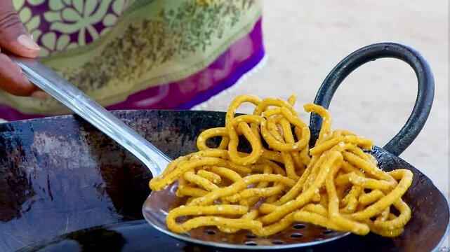 Sev, Alu bhujiya sev Indian snacks or namkeen, Directly pressing the sev maker into hot oil to make sev. Indian Snack Sev making process.