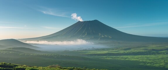 Fototapeta premium Majestic volcanic landscape under a clear sky with lush greenery and rolling hills