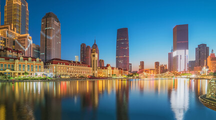 Obraz premium The urban architectural skyline, modern bridges, and Haihe River night scenery of Tianjin, China on August 11, 2024