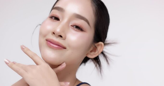 Slow motion of beautiful young Asian girl with k-beauty make up style on isolated white background for commercial beauty advertising.