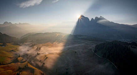 Aerial view of Dolomites in autumn fog at dawn