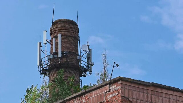 Cellular antennas and Internet on the brick pipe. 5G antennas mounted on a brick chimney