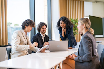 Fototapeta premium Group creative diverse business meeting discussing strategy startup project analysis finance process.Success business people work plan and brainstorm marketing idea with laptop in office.Teamwork
