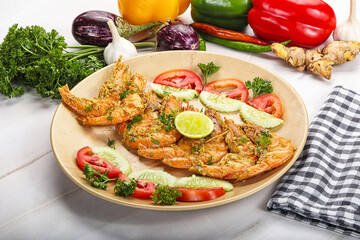 Grilled prawn served lime and vegetables