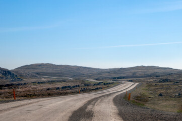 Northern Iceland, view of winding gravel road across desolate landscape