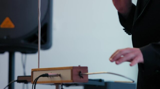 Playing the theremin. The theremin, etherphone, thereminophone or termenvox, thereminvox, is an electronic musical instrument controlled without physical contact by the performer. Patented in 1928