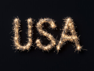 Custom light display spells USA in sparkling letters against a dark background around celebration time